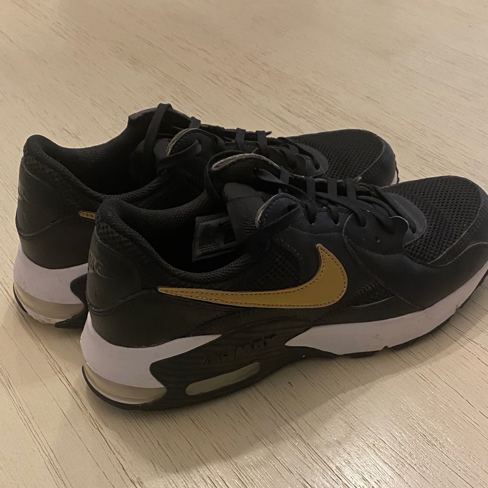 Nike Black Sneakers with Gold Swoosh and White Midsole